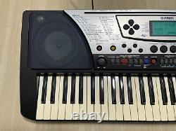 Yamaha PSR-340 Portatone Electronic Keyboard with Music Stand and Adapter